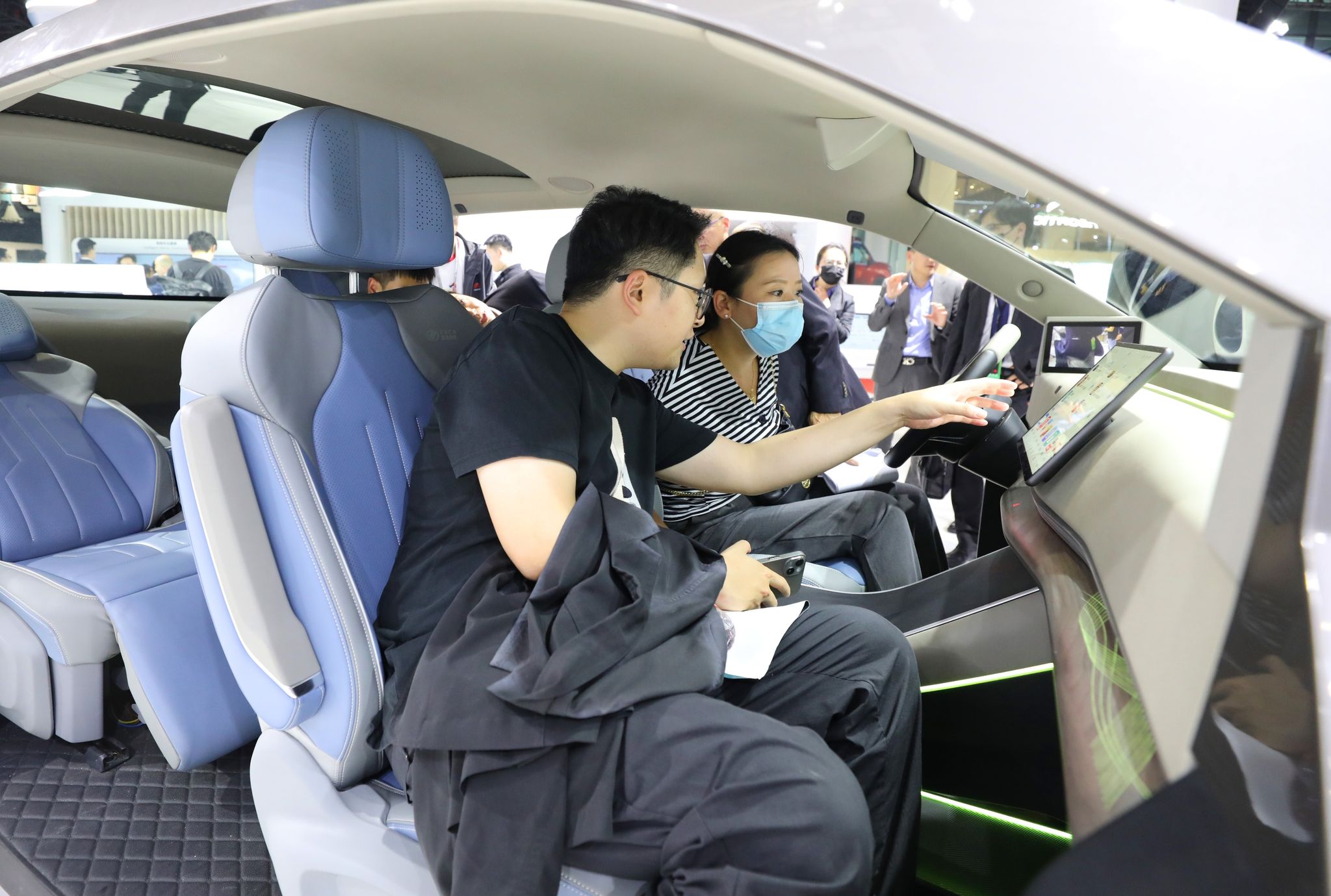 Besucher probieren ein HarmonyOS-basiertes intelligentes Bordcomputerterminal am Huawei-Stand auf der 20. internationalen Automobilausstellung «Auto Shanghai 2023».